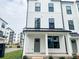 Charming townhouse featuring a modern farmhouse design with white siding and black accents at 12110 Storm Ln # 49, Charlotte, NC 28277