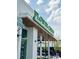 The Flower restaurant with a green awning, signage, and outdoor seating at 12110 Storm Ln # 49, Charlotte, NC 28277