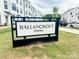 The Ballancroft Towns community sign on a green lawn with townhouses in the background at 12110 Storm Ln # 49, Charlotte, NC 28277