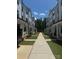 Townhomes with a sidewalk and green grass at 12110 Storm Ln # 49, Charlotte, NC 28277