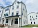 Two-story exterior showcasing the modern farmhouse design and well-manicured lawn at 12126 Storm Ln # 53, Charlotte, NC 28277