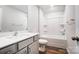 Clean bathroom featuring vanity, mirror, and shower-tub combination with white tile surround at 2608 Tillman St, Monroe, NC 28112