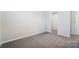 A carpeted bedroom with a closet and white walls creates a calm and soothing ambiance at 2608 Tillman St, Monroe, NC 28112