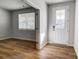 Bright bedroom with wood floors and a window, next to a door that leads to the outside at 2608 Tillman St, Monroe, NC 28112