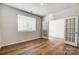 Bright bedroom featuring french doors, wood flooring, and window at 2608 Tillman St, Monroe, NC 28112