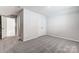 Cozy bedroom featuring neutral carpet, double door closet, and connecting bathroom at 2608 Tillman St, Monroe, NC 28112