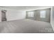 Spacious bonus room with neutral walls and soft carpet, offering a versatile living area at 2608 Tillman St, Monroe, NC 28112