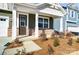 Inviting front porch with decorative columns, stone accents, and landscaping at 2608 Tillman St, Monroe, NC 28112
