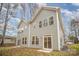 Home exterior featuring light green siding, multiple windows, and a sliding glass door to the back yard at 9251 Eleanor Dr, Charlotte, NC 28214