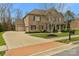 Two-story brick home with a three-car garage and landscaped yard at 2714 Stonewood Vw, Kannapolis, NC 28081