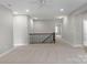 Spacious upper hallway with carpeted floors and access to bedrooms at 2714 Stonewood Vw, Kannapolis, NC 28081