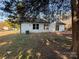 Back exterior view of house with large backyard and mature trees around perimeter for enhanced privacy at 4500 Doves Nest Ct, Matthews, NC 28105