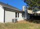 Exterior view of the home, featuring a chimney and modern air conditioning unit at 4500 Doves Nest Ct, Matthews, NC 28105