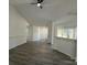 Open living room featuring neutral walls, modern flooring, and an open layout to the kitchen and dining area at 4500 Doves Nest Ct, Matthews, NC 28105