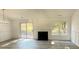 An open living space featuring a fireplace and natural light with modern flooring at 4500 Doves Nest Ct, Matthews, NC 28105