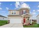 Two-story house with red door and attached garage at 736 Olde England Dr, Lincolnton, NC 28092