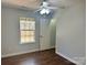 Bedroom with hardwood floors, ceiling fan, and backyard view at 841 Settlement Dr, Clover, SC 29710