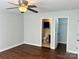 Bedroom with hardwood floors, ceiling fan, and en-suite bathroom access at 841 Settlement Dr, Clover, SC 29710