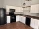 Modern kitchen with white cabinets, stainless steel appliances, and dark countertops at 841 Settlement Dr, Clover, SC 29710