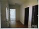 Hallway view with hardwood floors and multiple doorways leading to different rooms at 1020 N Shiloh Rd, York, SC 29745