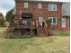 Wooden deck with a table and grill overlooking the landscaped backyard at 2304 Fox Hunt Dr, Monroe, NC 28110