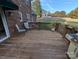 Wooden deck with chairs and a grill overlooking the backyard at 2304 Fox Hunt Dr, Monroe, NC 28110