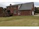 Brick home with a wooden deck and a spacious yard at 2304 Fox Hunt Dr, Monroe, NC 28110