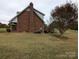 Brick home exterior showcasing a deck and spacious backyard at 2304 Fox Hunt Dr, Monroe, NC 28110