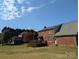Brick home with a wooden deck and a spacious lawn at 2304 Fox Hunt Dr, Monroe, NC 28110
