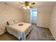 Bright bedroom with double bed and floral wallpaper at 2304 Fox Hunt Dr, Monroe, NC 28110