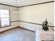Bright dining room with carpet, chair rail trim, and a vintage chandelier at 2304 Fox Hunt Dr, Monroe, NC 28110