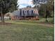 Charming brick home with a well-manicured lawn and inviting front porch at 2304 Fox Hunt Dr, Monroe, NC 28110