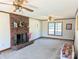 Spacious living room featuring a brick fireplace and large windows at 2304 Fox Hunt Dr, Monroe, NC 28110