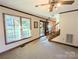 Bright living room with hardwood floors, a fireplace, and a staircase at 2304 Fox Hunt Dr, Monroe, NC 28110
