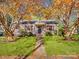 Charming home with lush front lawn, red shutters, sidewalk, and mature trees with fall foliage at 412 Keels Ave, Rock Hill, SC 29730