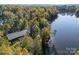 Aerial view of a lakefront home, revealing stunning trees, a lake, and a private dock at 7095 Sunset Crater Pl, Lancaster, SC 29720