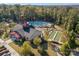 Overhead shot of the community pool, clubhouse, and recreational areas surrounded by lush greenery and well-maintained grounds at 7095 Sunset Crater Pl, Lancaster, SC 29720