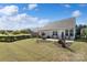 Expansive backyard with a patio, lovely landscaping, and a well-kept lawn, ideal for Gathering gatherings and outdoor activities at 7095 Sunset Crater Pl, Lancaster, SC 29720