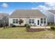 Well-maintained backyard with green lawn, stone patio, and neat landscaping, perfect for outdoor relaxation and entertaining at 7095 Sunset Crater Pl, Lancaster, SC 29720