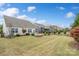 Spacious backyard with green grass, a stone patio, and tasteful landscaping, offering a private and inviting outdoor space at 7095 Sunset Crater Pl, Lancaster, SC 29720