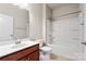 Clean bathroom featuring a tub with shower, white walls and fixtures, and a wood cabinet with a sink at 7095 Sunset Crater Pl, Lancaster, SC 29720