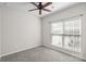 Neutral bedroom features carpet, ample natural light from a large window, and a ceiling fan for added comfort at 7095 Sunset Crater Pl, Lancaster, SC 29720