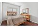 Bright bedroom with hardwood floors, a decorative mirror, neutral walls and a comfortable bed to unwind in at 7095 Sunset Crater Pl, Lancaster, SC 29720