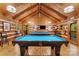 Spacious game room with two pool tables, wood paneled walls and ceiling, and ample lighting at 7095 Sunset Crater Pl, Lancaster, SC 29720