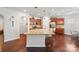 Bright, open kitchen featuring granite countertops, stainless appliances, and an eat-in island with bar stools at 7095 Sunset Crater Pl, Lancaster, SC 29720