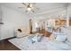 Open living area featuring hardwood floors, natural light, ceiling fan, neutral walls, and seamless flow to the kitchen at 7095 Sunset Crater Pl, Lancaster, SC 29720