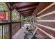 Inviting wooden porch with rocking chairs, offering a relaxing outdoor space at this rustic cabin-style business center at 7095 Sunset Crater Pl, Lancaster, SC 29720