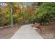 Picturesque community walking path featuring benches, trees, and landscape lighting at 7095 Sunset Crater Pl, Lancaster, SC 29720