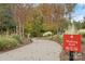 Community walking trail with lush greenery and signage, promoting an active lifestyle at 7095 Sunset Crater Pl, Lancaster, SC 29720