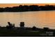 Two chairs on lakeside patio at sunset at 928 Southwest Dr, Davidson, NC 28036